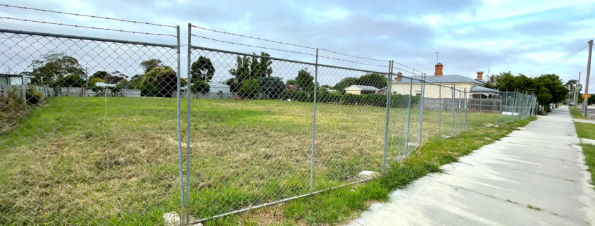 Planning due diligence checks - image of vacant block with wire fence around it.